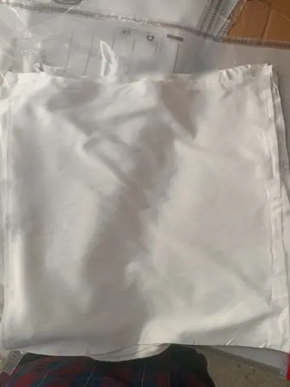 A stack of square white cut pieces with finished edges